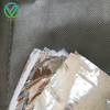 Micro-pore texture close-up of punctured MPET fabric, evenly punched holes for breathability as outer skin of cold-proof thermal blankets