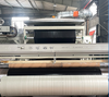 Assembly line shot of black-white kraft woven laminate, UV barrier black side for long-distance building goods delivery