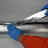 On-site wrapping construction shot of flame retardant fiberglass tape on heat transfer industrial pipelines