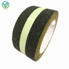 Single roll diagonal shot of black-green luminous anti slip tape, bright glowing strip for basement stair night anti-fall marking