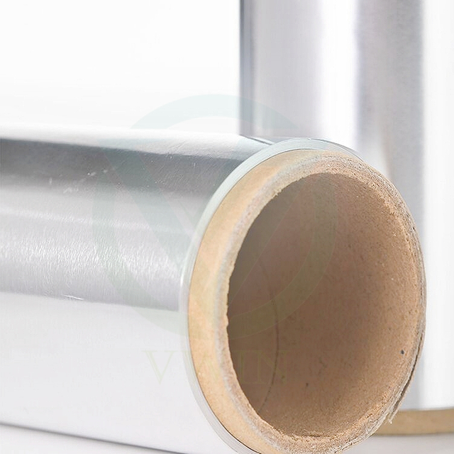 Close-up of large industrial aluminum foil roll, representing raw material supply and mass production capability.