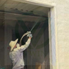 Worker inspecting PP woven laminated mineral wool roll for underfloor heating insulation