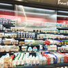 Self coiling perforated transparent night curtain fitted on beverage and dairy freezer showcase