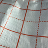 Close-up of red grid reinforced printed PP fabric, high density for tear-resistant insulation laying construction