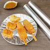 Aluminum foil wrapping food for cooking and storage, showcasing practical kitchen usage.