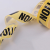 Folded close-up of translucent yellow warning tape, soil & water resistant for long-term underground gas pipeline marking