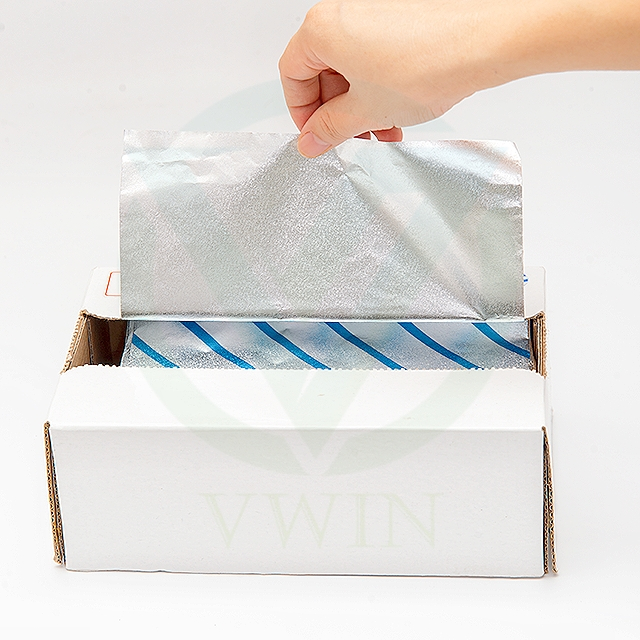 Dynamic shot: Hand easily pulling aluminum foil sheets from a white box, demonstrating user-friendly design