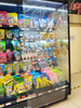Self coiling perforated transparent night curtain installed on supermarket multi‑goods freezer display case
