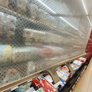 Breathable anti‑condensation plastic night blind installed on supermarket freezer display case