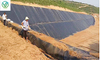 Full view of fish pond anti-leakage project with black woven geotextile, anti-seepage lining & slope protection material