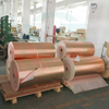 Mass stock of large rolls of raw gold aluminum foil fiberglass cloth in factory warehouse